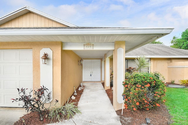 515 SE Nome Dr, Port Saint Lucie, FL 34984 - doorway to property featuring stucco siding and a shingled roof