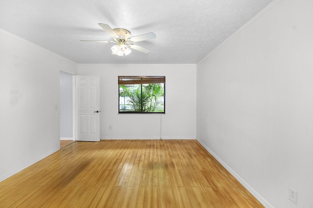 515 SE Nome Dr, Port Saint Lucie, FL 34984 - empty room featuring light wood-style floors, a ceiling fan, a textured ceiling, baseboards, and crown molding