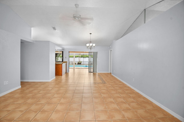 515 SE Nome Dr, Port Saint Lucie, FL 34984 - unfurnished room with a ceiling fan, light tile patterned floors, lofted ceiling, a chandelier, and baseboards