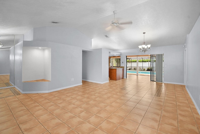 515 SE Nome Dr, Port Saint Lucie, FL 34984 - unfurnished room featuring ceiling fan, lofted ceiling, baseboards, a chandelier, and light tile patterned floors