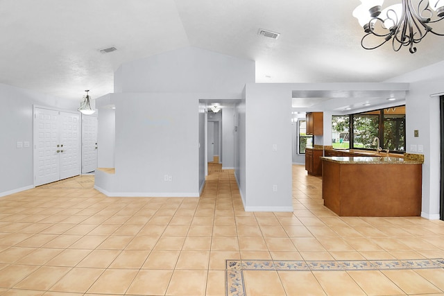 515 SE Nome Dr, Port Saint Lucie, FL 34984 - unfurnished living room featuring lofted ceiling, light tile patterned floors, a chandelier, and baseboards