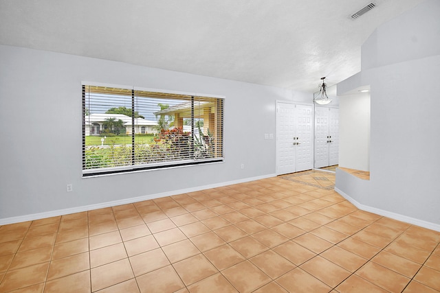 515 SE Nome Dr, Port Saint Lucie, FL 34984 - unfurnished room with light tile patterned flooring and baseboards