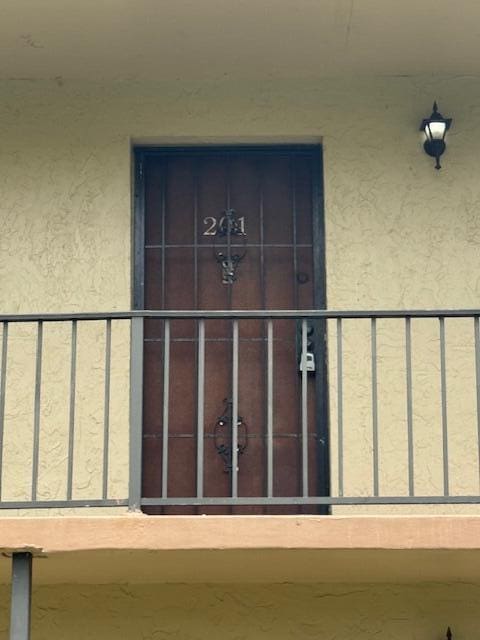 6080 Forest Hill Blvd Unit 201, West Palm Beach, FL 33415 - view of exterior entry featuring stucco siding
