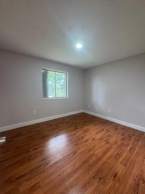6080 Forest Hill Blvd Unit 201, West Palm Beach, FL 33415 - empty room featuring baseboards and wood finished floors