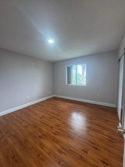 6080 Forest Hill Blvd Unit 201, West Palm Beach, FL 33415 - spare room featuring baseboards and wood finished floors