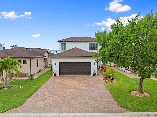 260 SE Via Visconti, Port Saint Lucie, FL 34952 - view of front facade with stucco siding, a garage, decorative driveway, a front yard, and a shingled roof