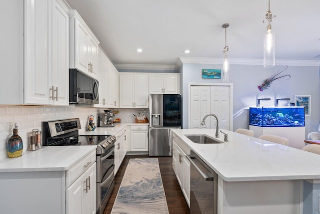 260 SE Via Visconti, Port Saint Lucie, FL 34952 - kitchen with appliances with stainless steel finishes, a sink, ornamental molding, an island with sink, and white cabinets