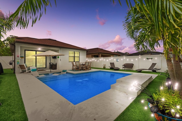 260 SE Via Visconti, Port Saint Lucie, FL 34952 - view of swimming pool with a fenced backyard, outdoor dining space, and a patio area