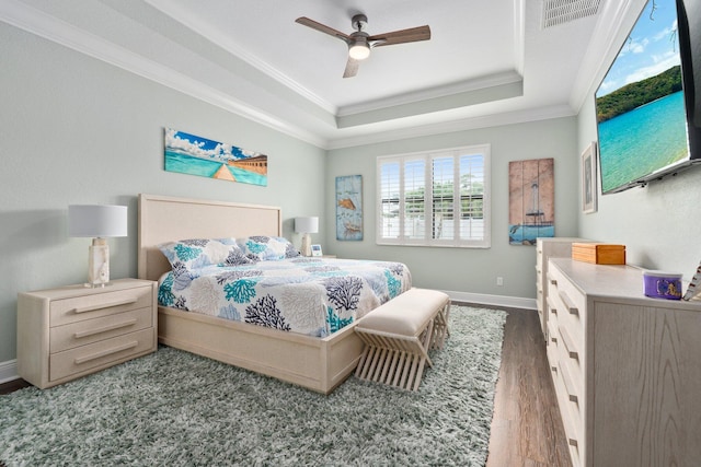 260 SE Via Visconti, Port Saint Lucie, FL 34952 - bedroom featuring a raised ceiling, crown molding, wood finished floors, baseboards, and a ceiling fan