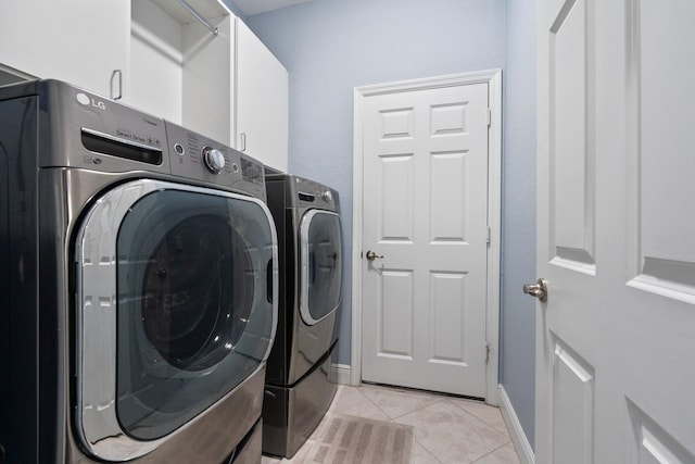 260 SE Via Visconti, Port Saint Lucie, FL 34952 - washroom featuring washer and dryer, cabinet space, light tile patterned floors, and baseboards