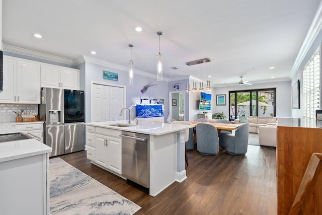 260 SE Via Visconti, Port Saint Lucie, FL 34952 - kitchen with stainless steel appliances, a sink, open floor plan, white cabinets, and recessed lighting
