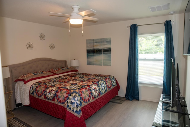 1122 SW California Blvd SW, Port Saint Lucie, FL 34953 - bedroom featuring wood finished floors, a ceiling fan, and baseboards