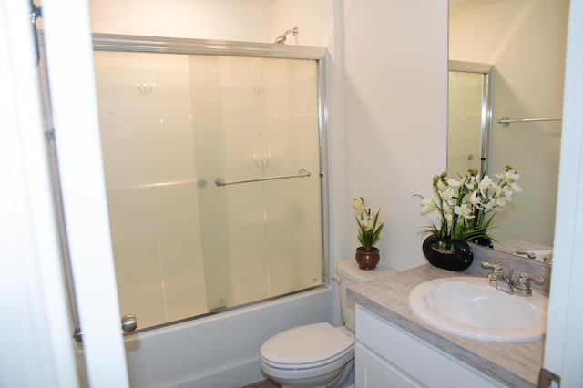 1122 SW California Blvd SW, Port Saint Lucie, FL 34953 - bathroom with vanity, toilet, and bath / shower combo with glass door