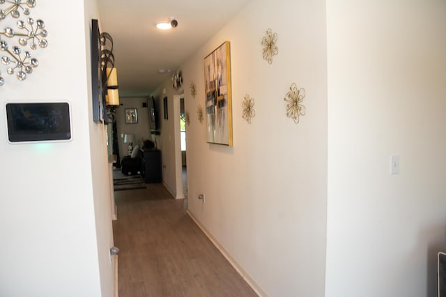 1122 SW California Blvd SW, Port Saint Lucie, FL 34953 - hallway featuring light wood finished floors and baseboards