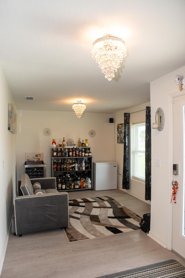 1122 SW California Blvd SW, Port Saint Lucie, FL 34953 - living room with a chandelier, wood finished floors, and baseboards