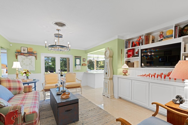 4633 Holly Dr, Palm Beach Gardens, FL 33418 - living room with french doors, a chandelier, crown molding, and a wainscoted wall