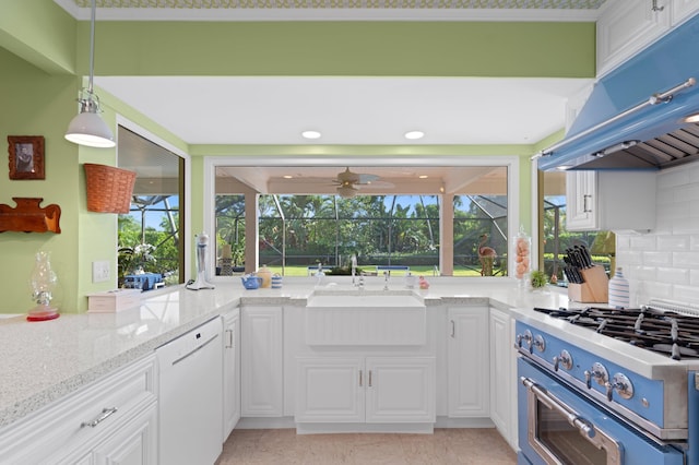4633 Holly Dr, Palm Beach Gardens, FL 33418 - kitchen with dishwasher, gas stove, exhaust hood, a sink, and white cabinetry
