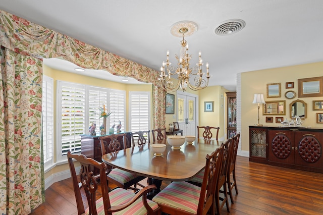 4633 Holly Dr, Palm Beach Gardens, FL 33418 - dining space featuring wood-type flooring, a chandelier, and baseboards