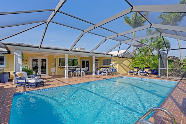 4633 Holly Dr, Palm Beach Gardens, FL 33418 - outdoor pool with french doors, a patio, a ceiling fan, and glass enclosure