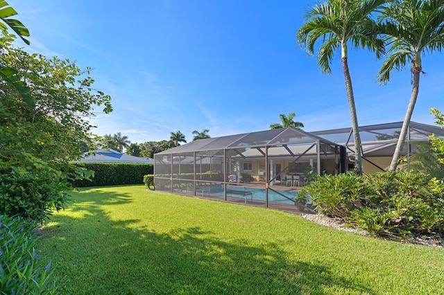 4633 Holly Dr, Palm Beach Gardens, FL 33418 - view of grassy yard with an outdoor pool and a lanai