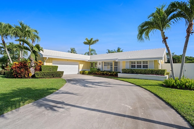 4633 Holly Dr, Palm Beach Gardens, FL 33418 - ranch-style home with driveway, an attached garage, and a tile roof
