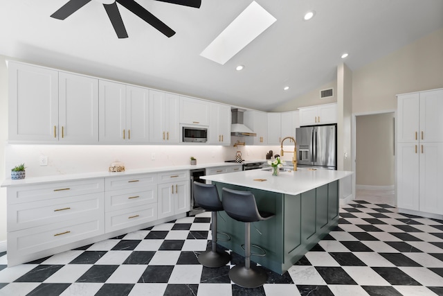 4902 SW Bimini Cir N, Palm City, FL 34990 - kitchen with stainless steel appliances, wall chimney exhaust hood, tile patterned floors, light countertops, and a ceiling fan