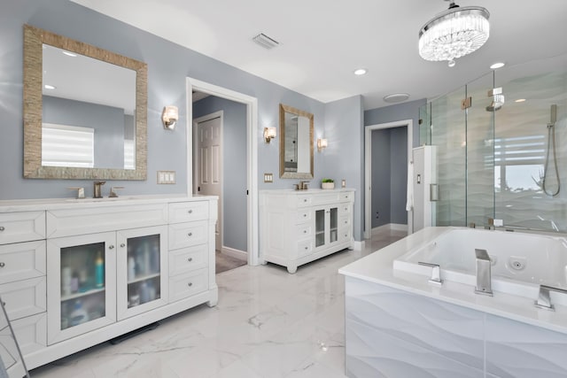 4902 SW Bimini Cir N, Palm City, FL 34990 - full bath featuring a shower stall, a tub with jets, two vanities, a chandelier, and marble finish floors