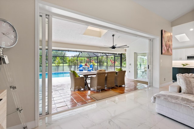 4902 SW Bimini Cir N, Palm City, FL 34990 - living room featuring a skylight, lofted ceiling, a ceiling fan, and a sunroom