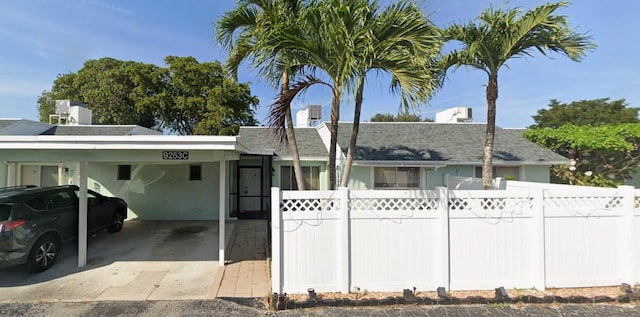 9253 SW 5th St Unit C, Boca Raton, FL 33428 - ranch-style house with a carport and a shingled roof