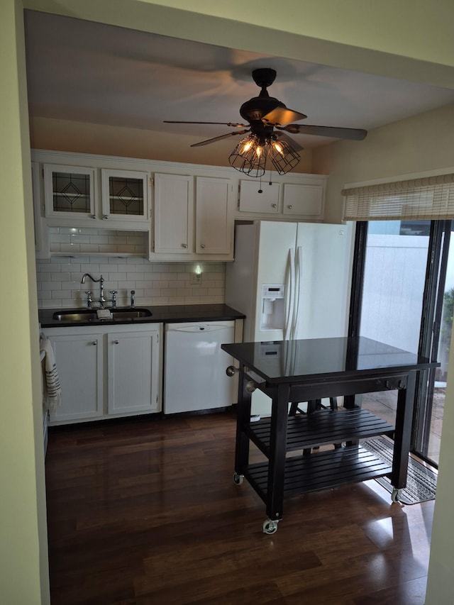 9253 SW 5th St Unit C, Boca Raton, FL 33428 - kitchen featuring white appliances, a sink, dark countertops, and backsplash