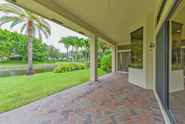 3583 Collonade Dr, Wellington, FL 33449 - view of patio with a water view
