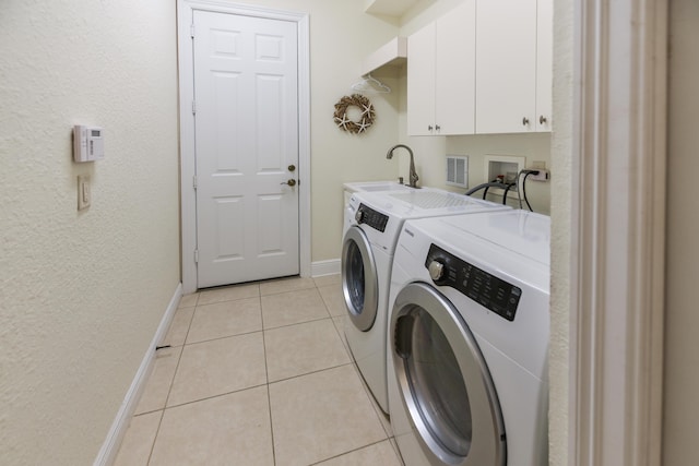 3583 Collonade Dr, Wellington, FL 33449 - washroom with washer and clothes dryer, cabinet space, baseboards, and light tile patterned floors