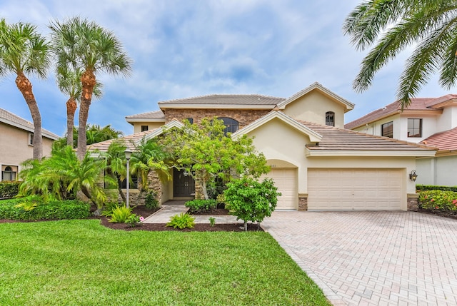 3583 Collonade Dr, Wellington, FL 33449 - mediterranean / spanish-style house with decorative driveway, a front yard, stucco siding, and a tile roof