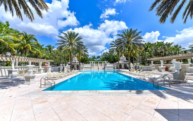 3583 Collonade Dr, Wellington, FL 33449 - community pool with an outdoor fireplace and a patio area