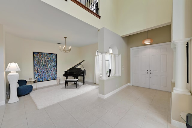 3583 Collonade Dr, Wellington, FL 33449 - foyer entrance with ornate columns, light tile patterned flooring, a towering ceiling, baseboards, and a chandelier