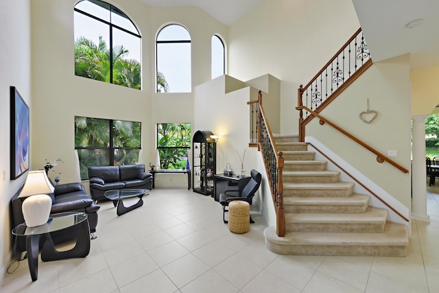 3583 Collonade Dr, Wellington, FL 33449 - living room featuring plenty of natural light, stairs, tile patterned floors, and a high ceiling