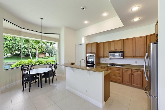 3583 Collonade Dr, Wellington, FL 33449 - kitchen with appliances with stainless steel finishes, brown cabinetry, light tile patterned floors, baseboards, and recessed lighting