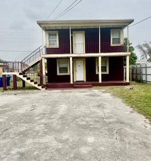 1260 Dr Martin Luther King Jr Blvd, Riviera Beach, FL 33404 - view of property featuring a balcony, covered porch, and stairs