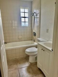 1260 Dr Martin Luther King Jr Blvd, Riviera Beach, FL 33404 - full bathroom featuring toilet, tile patterned flooring, vanity, and tiled shower / bath combo