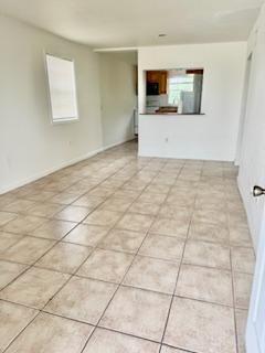 1260 Dr Martin Luther King Jr Blvd, Riviera Beach, FL 33404 - spare room with plenty of natural light and light tile patterned floors