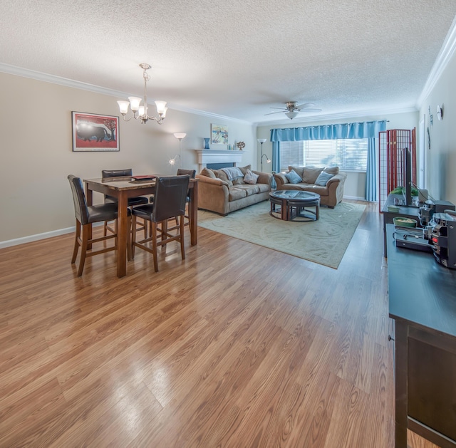 1516 S Lakeside Dr Unit 205, Lake Worth Beach, FL 33460 - dining room with a textured ceiling, ornamental molding, a chandelier, light wood finished floors, and ceiling fan