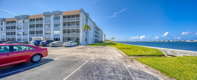 1516 S Lakeside Dr Unit 205, Lake Worth Beach, FL 33460 - view of apartment building / complex with uncovered parking and a water view