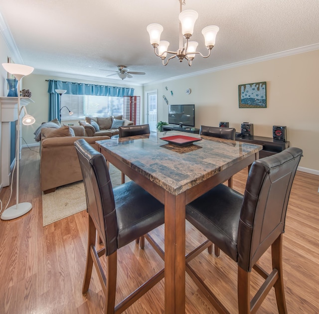 1516 S Lakeside Dr Unit 205, Lake Worth Beach, FL 33460 - dining space featuring ornamental molding, light wood-type flooring, ceiling fan, and a chandelier
