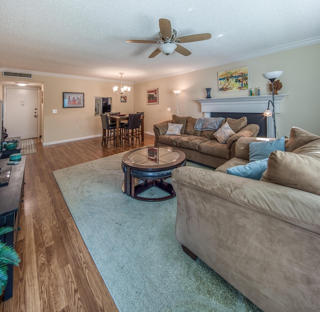 1516 S Lakeside Dr Unit 205, Lake Worth Beach, FL 33460 - living room with ornamental molding, a ceiling fan, wood finished floors, a chandelier, and a textured ceiling