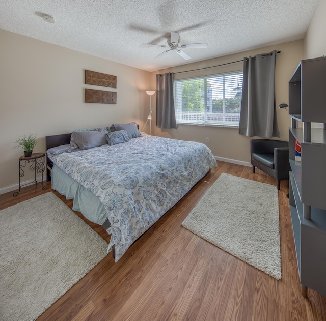 1516 S Lakeside Dr Unit 205, Lake Worth Beach, FL 33460 - bedroom with a textured ceiling, wood finished floors, and a ceiling fan