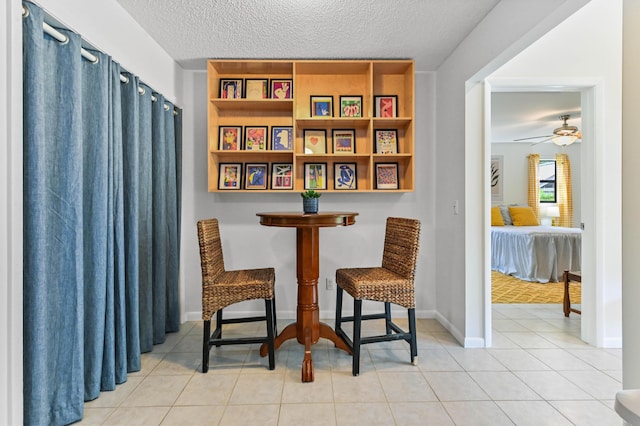 17183 76th St N, Loxahatchee, FL 33470 - sitting room featuring a textured ceiling, ceiling fan, tile patterned floors, and baseboards