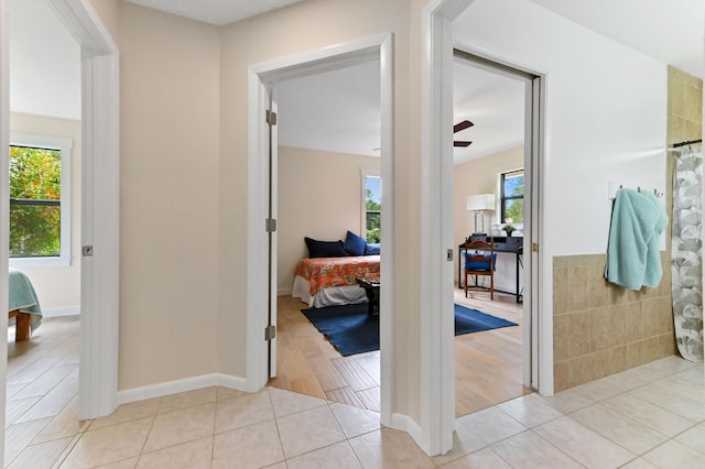 17183 76th St N, Loxahatchee, FL 33470 - hall with plenty of natural light and light tile patterned flooring