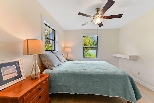 17183 76th St N, Loxahatchee, FL 33470 - bedroom with multiple windows, wood finished floors, baseboards, and ceiling fan