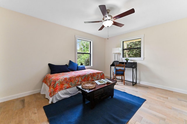 17183 76th St N, Loxahatchee, FL 33470 - bedroom with multiple windows, wood finished floors, and baseboards