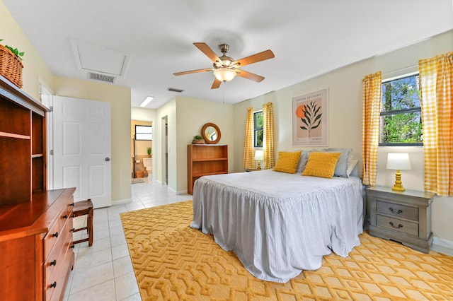 17183 76th St N, Loxahatchee, FL 33470 - bedroom with light tile patterned flooring, attic access, baseboards, and ensuite bathroom